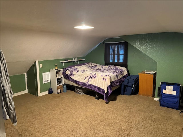 carpeted bedroom with baseboards and lofted ceiling