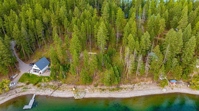 aerial view of property and surrounding area with a forest