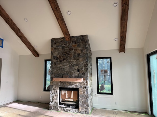 unfurnished living room with baseboards and a stone fireplace