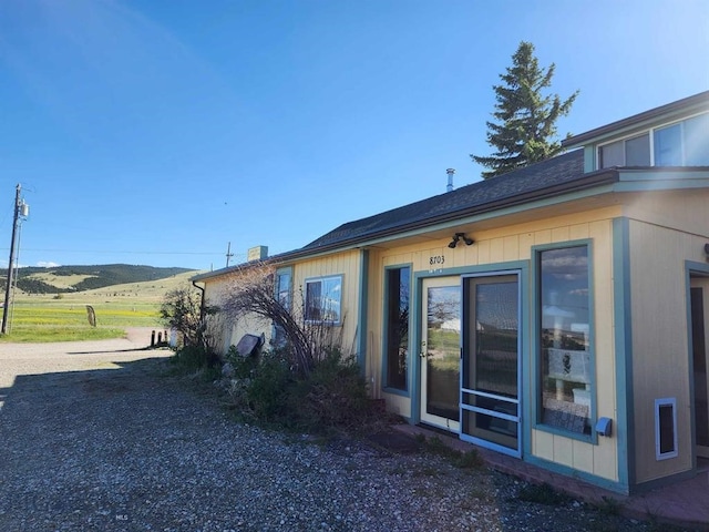 view of side of home with a mountain view