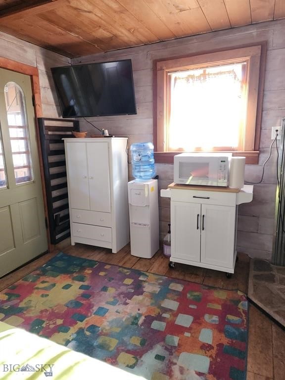 laundry room with wood ceiling and hardwood / wood-style floors