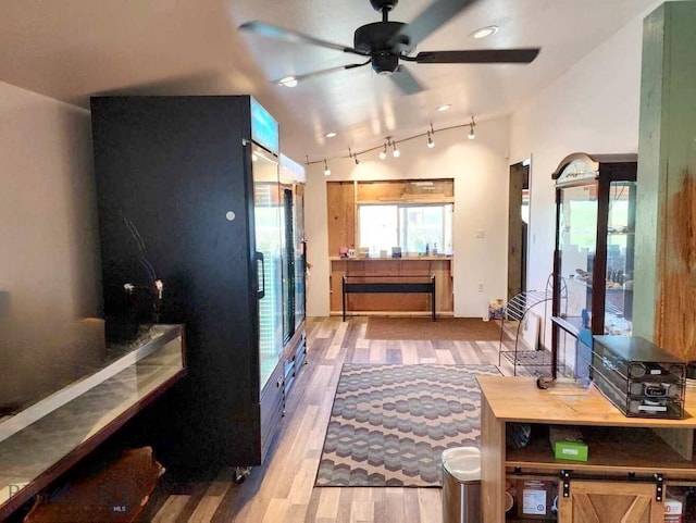 interior space with lofted ceiling, light hardwood / wood-style floors, and ceiling fan