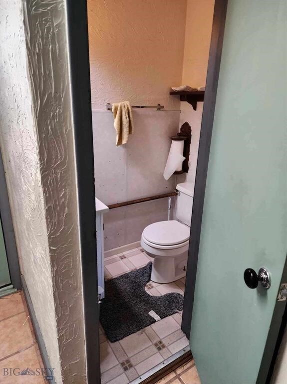 bathroom featuring tile patterned floors and toilet