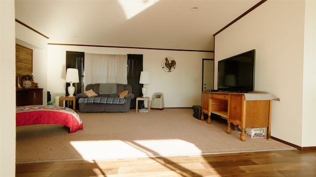 bedroom featuring ornamental molding and hardwood / wood-style floors