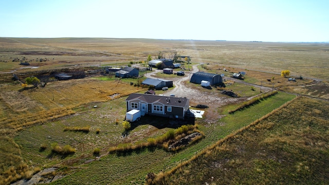 birds eye view of property with a rural view