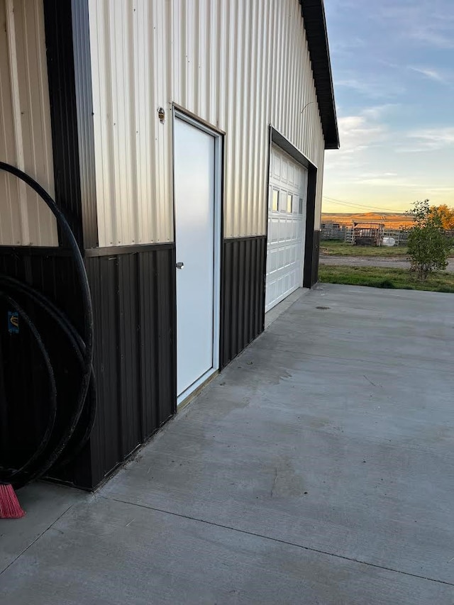 view of garage at dusk