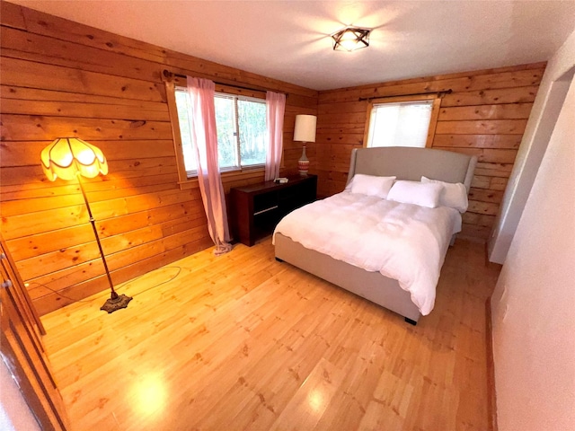 339 Dakota Ave, Whitefish, MT 59937 - bedroom with light wood-type flooring and wooden walls