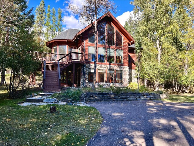 339 Dakota Ave, Whitefish, MT 59937 - view of front of home featuring stairs, stone siding, and a deck