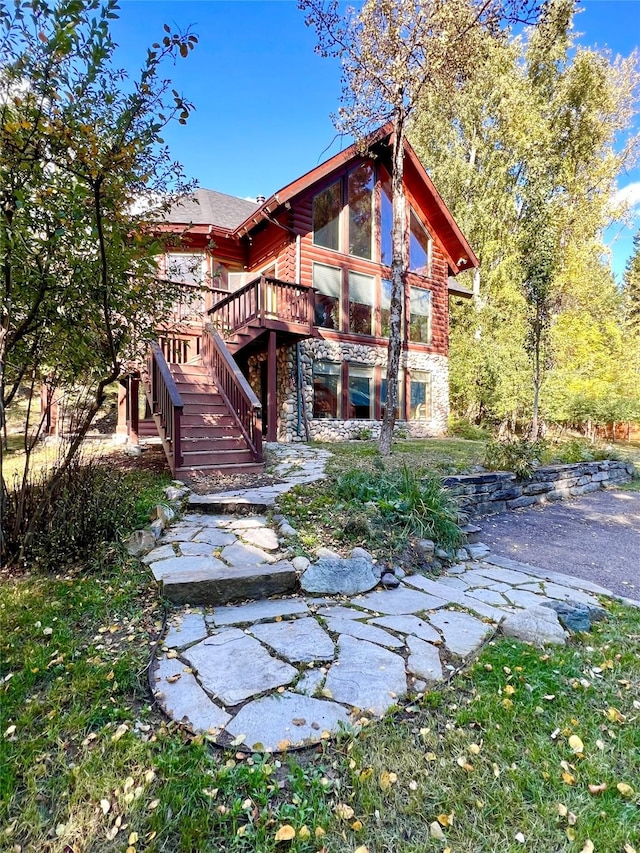 339 Dakota Ave, Whitefish, MT 59937 - back of property featuring stone siding, stairs, and a deck