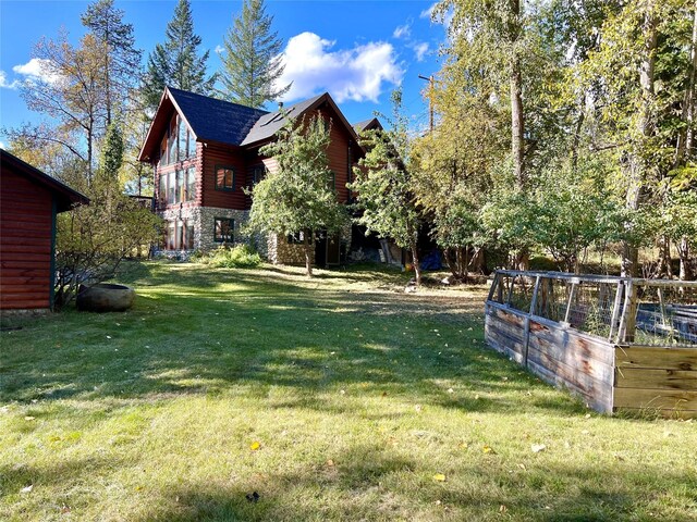 339 Dakota Ave, Whitefish, MT 59937 - view of green lawn featuring a garden