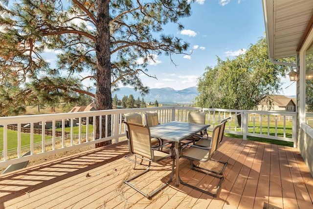 back of house featuring a wooden deck, a yard, and a patio