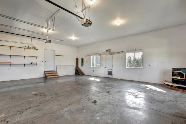 garage with a garage door opener and heating unit