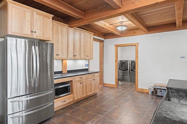 1200 Shaw Ln, Bonner, MT 59823 - kitchen featuring stainless steel appliances, wood ceiling, light brown cabinetry, washer and clothes dryer, and dark countertops
