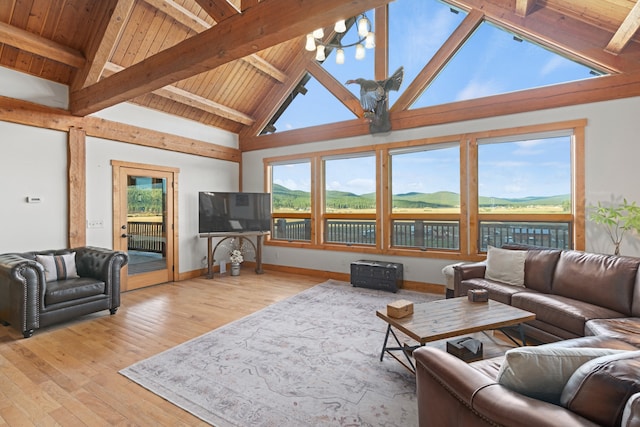 living room featuring wood ceiling, light hardwood / wood-style floors, beam ceiling, high vaulted ceiling, and an inviting chandelier