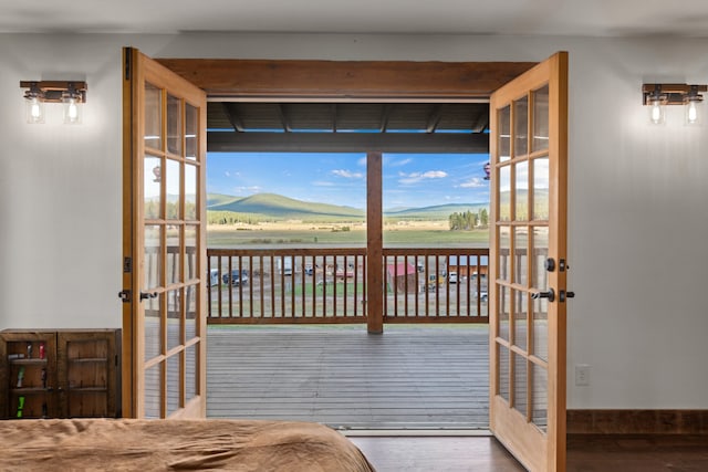 doorway to outside featuring a wealth of natural light, french doors, a mountain view, and hardwood / wood-style flooring