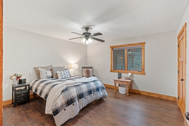 bedroom featuring ceiling fan, a textured ceiling, and dark wood-type flooring