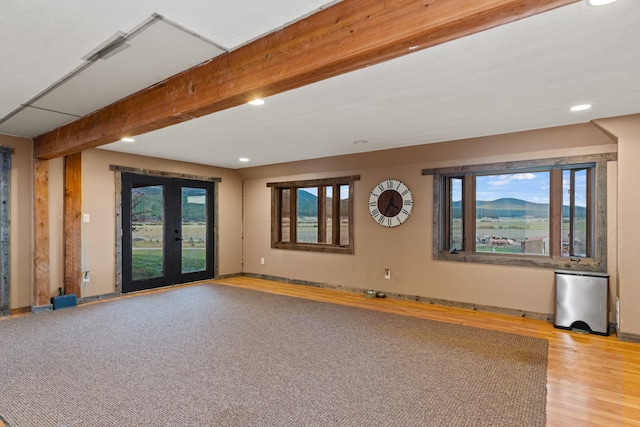 interior space with french doors, beamed ceiling, and hardwood / wood-style floors