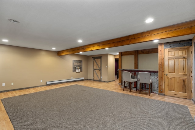 basement with baseboard heating and light hardwood / wood-style floors