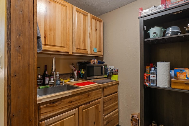 1200 Shaw Ln, Bonner, MT 59823 - kitchen featuring stainless steel microwave, a sink, and a textured ceiling