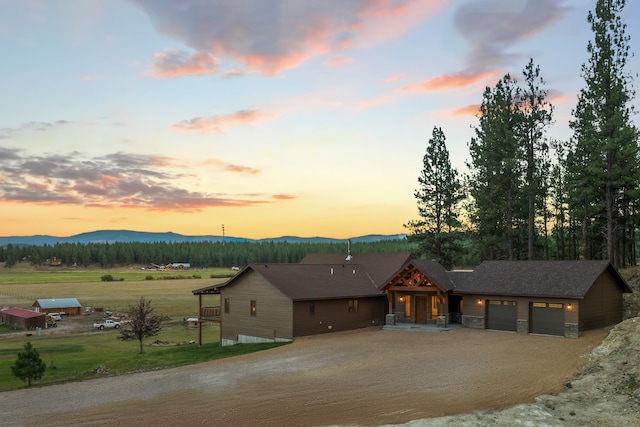 view of front of home with a mountain view and a garage