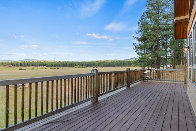 deck featuring a rural view and a yard