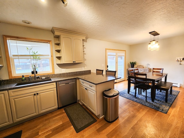 kitchen with pendant lighting, dishwasher, dark hardwood / wood-style floors, and kitchen peninsula