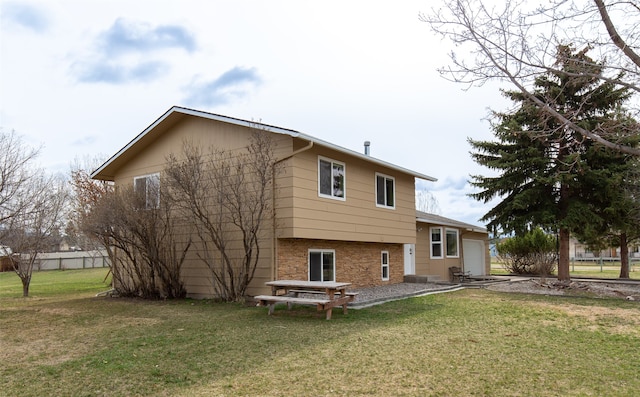 back of house with a yard and a patio