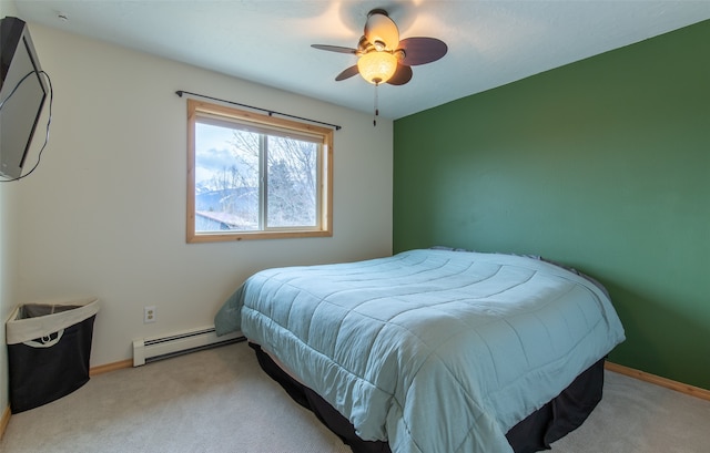 carpeted bedroom with a baseboard heating unit and ceiling fan