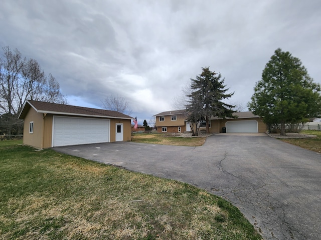 view of front of property with a garage and a front lawn