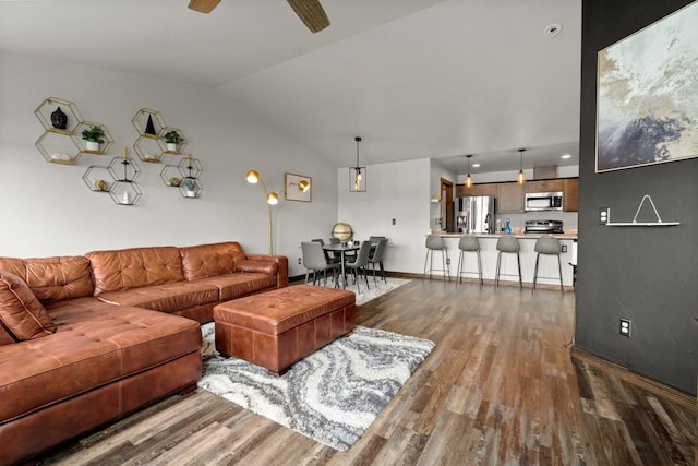 living room with vaulted ceiling, baseboards, ceiling fan, and dark wood finished floors