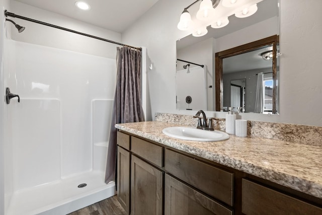 bathroom featuring vanity, wood finished floors, and a shower with shower curtain