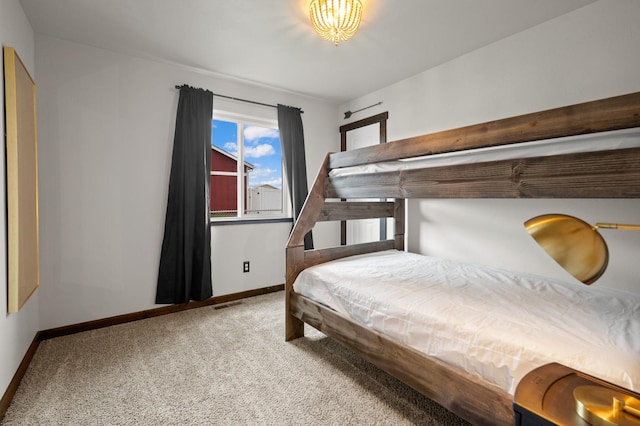 bedroom featuring carpet floors, visible vents, and baseboards