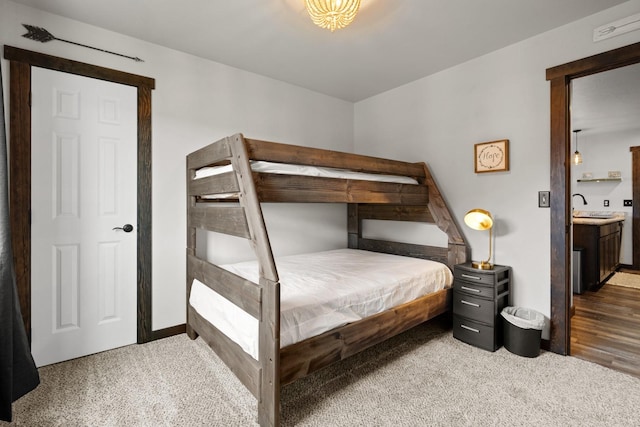 carpeted bedroom featuring a sink