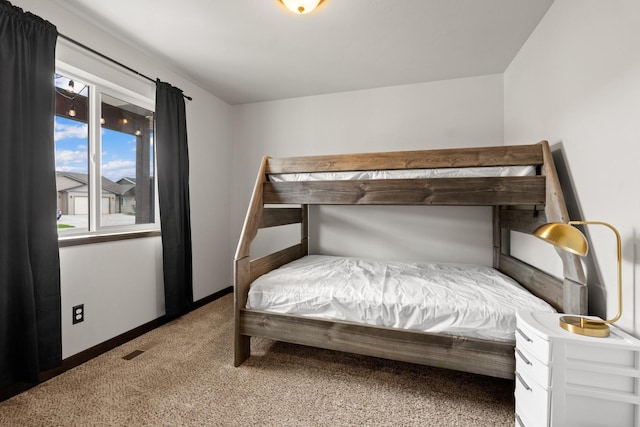 bedroom with carpet flooring and baseboards