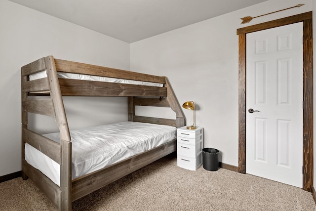 bedroom featuring carpet floors and baseboards