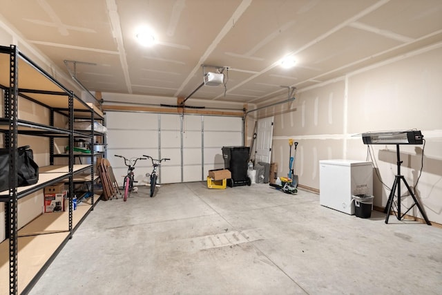 garage with a garage door opener and fridge