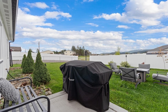 view of patio with grilling area and a fenced backyard