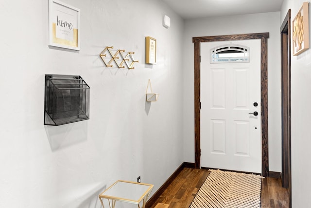 entryway featuring baseboards and dark wood-type flooring
