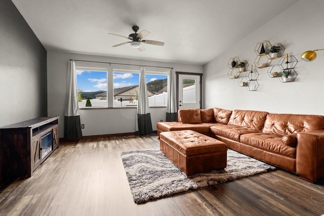 living area featuring a ceiling fan and wood finished floors