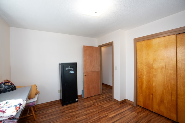 office with a textured ceiling and dark hardwood / wood-style flooring