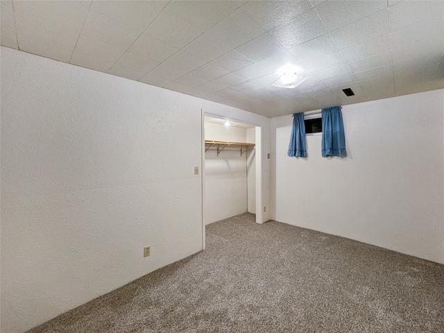 unfurnished bedroom with a closet, carpet, and a spacious closet