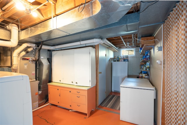 basement featuring washer / clothes dryer and white fridge