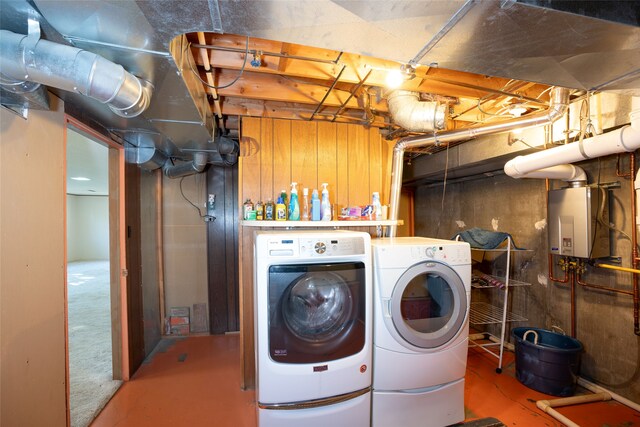 laundry room with washer and clothes dryer and water heater