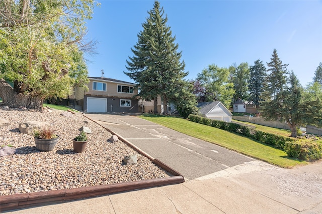 view of front of house with a front yard and a garage