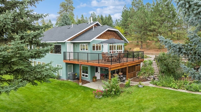 back of property featuring a lawn, cooling unit, a patio, and a wooden deck