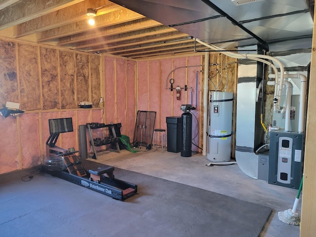 workout area with secured water heater, concrete flooring, and heating unit