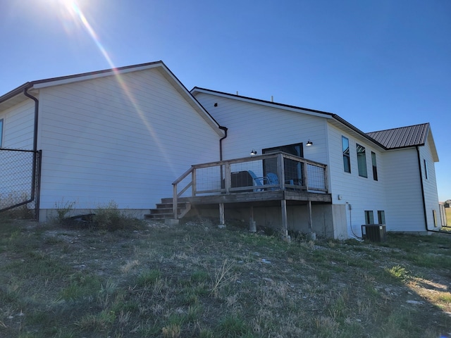 rear view of property featuring cooling unit