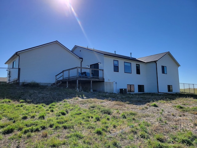 back of property featuring central AC