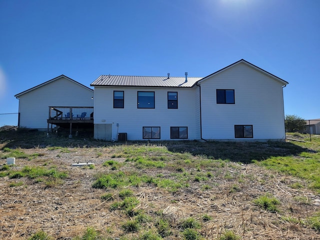 rear view of house with a deck and central air condition unit