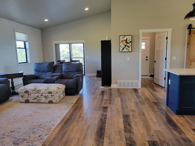 living room featuring hardwood / wood-style floors and high vaulted ceiling